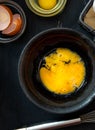 Beaten egg yolks in a bowl on a dark background Royalty Free Stock Photo