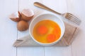 Beaten egg yolks in a bowl with fork