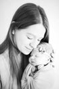 Beatific mother with long hair with beloved newborn daughter in hands Royalty Free Stock Photo