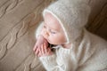 Beatiful baby boy in white knitted cloths and hat, sleeping Royalty Free Stock Photo