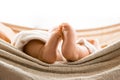 A BEATIFUL BABY GIRL IN A HAMMOCK SHOWING HER FEETS