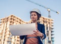 Beatiful business woman engineer is standing with plan papers. Royalty Free Stock Photo
