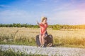 Beatiful girl doing hitchhiking on the road Royalty Free Stock Photo