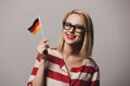 Beatiful girl in glasses holds German flag