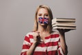 Beatiful girl holds British flag and books