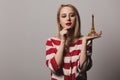 Beatiful girl holds golden Eiffel tower souvenir