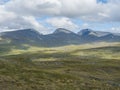 Beatiful northern landscape artic landscape, tundra in Swedish Lapland with green hills and mountains at Padjelantaleden Royalty Free Stock Photo