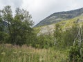 Beatiful northern landscape, tundra in Swedish Lapland with small waterfall, green hills and mountains at