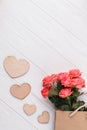 Beatiful rose flowers and wooden hearts.