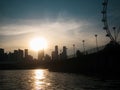 Beatiful sunset with sky and silhouette of city and ferris wheel. View from Bay Royalty Free Stock Photo