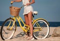 Beatiful woman with bike on the beach Royalty Free Stock Photo