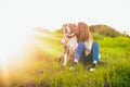 Beatiful young woman kissing dog in the field. American Staffordshire terrier Royalty Free Stock Photo