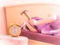 Beating the alarm clock with hammer. concept of sleep