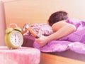 Beating the alarm clock with hammer. concept of sleep