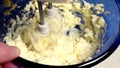 Beating butter in blue bowl with mixer