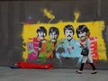 Beatles street art with rough sleeper