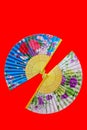 Beatufiful and colorful designs of oriental folding fans on red background 