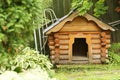 Beatuful formal garden landscape with log dog house close up photo Royalty Free Stock Photo