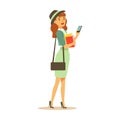 Beatuful student girl in fashionable clothes standing and holding smartphone and books in her hands. Student lifestyle