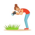 Beatuful woman taking picture of green grass with her camera. Colorful character vector Illustration