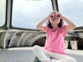 Beauiful girl focuses at the above in the air inside an air cabin room