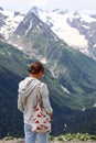 Beauiful young woman looks to the amazing picturesque mountain view