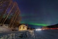 Beauitful aurora over the night sky, wooden house Royalty Free Stock Photo