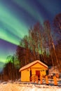 Beauitful aurora over the night sky, wooden house Royalty Free Stock Photo