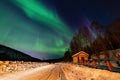 Beauitful aurora over the night sky, wooden house Royalty Free Stock Photo