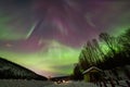 Beauitful aurora over the night sky, wooden house Royalty Free Stock Photo