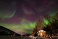 Beauitful aurora over the night sky, wooden house Royalty Free Stock Photo