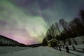 Beauitful aurora over the night sky, wooden house Royalty Free Stock Photo