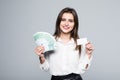 Beauitful woman holding some Euro currency notes and white blank in other hands for copy space isolated over white background