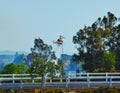 A helicopterBeaumont and Banning , California fire fighters responding to a grass fire on a hot day