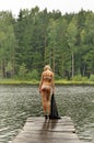 Beaurtiful woman at the lake's coastline.