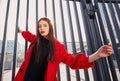 Beauteous extravagant girl with dark hair and gentle look hung on gate