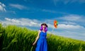 Purple hair girl with pinwheel at wheat field Royalty Free Stock Photo