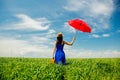 Girl with suitcase and umbrella at wheat field Royalty Free Stock Photo