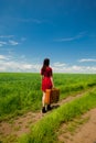 Girl with suitcase at wheat field Royalty Free Stock Photo