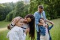 Beautfiul young family at meadow, enjoying together time.