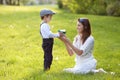 Beautful kid and mom in spring park, flower and present. Mothers Royalty Free Stock Photo