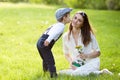 Beautful kid and mom in spring park, flower and present