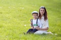 Beautful kid and mom in spring park, flower and present. Mothers Royalty Free Stock Photo