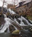 Beautful waterfall and an old mill in the swedish village Rottle during spring