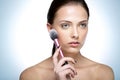 Beautful woman holding cosmetic brush Royalty Free Stock Photo