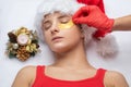 The beautician applies patches to moisturize the skin under the eyes. Skin care in winter