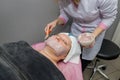 Beautician apply an alginate mask on the client`s face