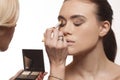 Beautician applying eye makeup