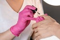 Beautician applying Polish nails