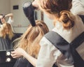 Beautician blow dry woman`s hair at beauty salon